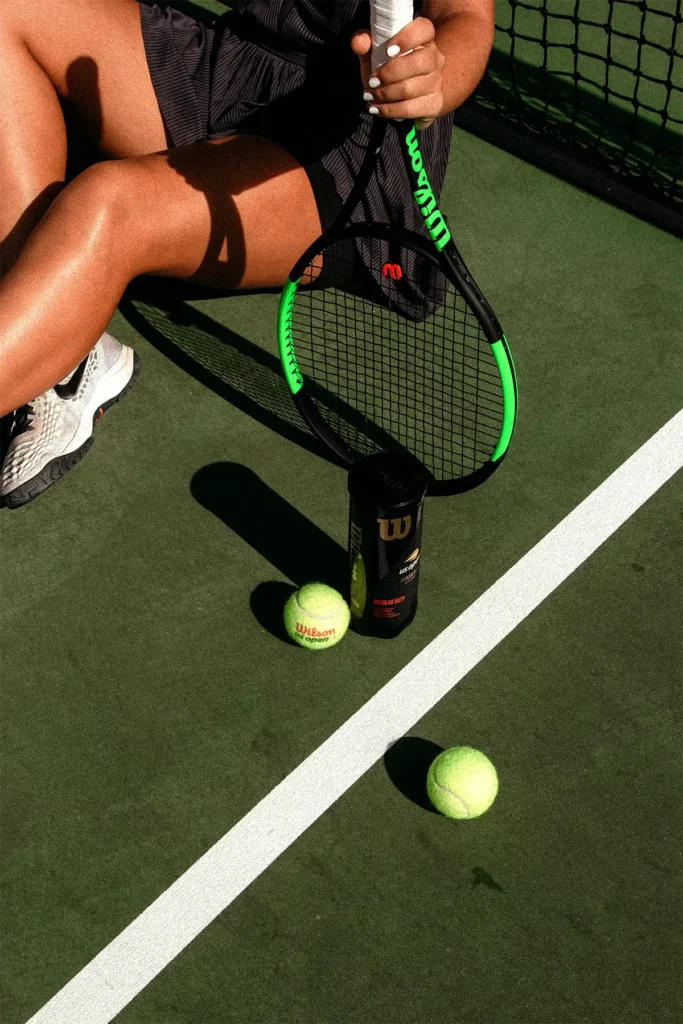 women sport equipment of tennis on a green court