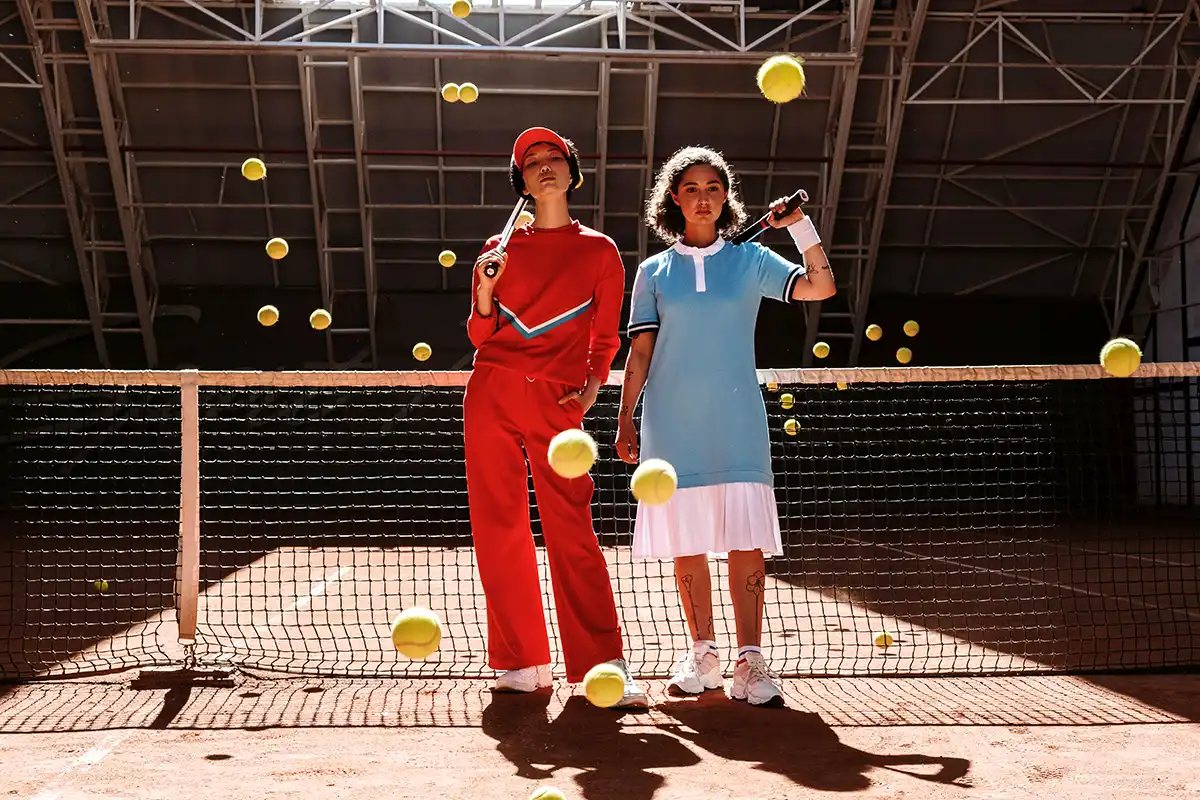 startup incubator is coaching a duo of tennis women ready to play on an interior court